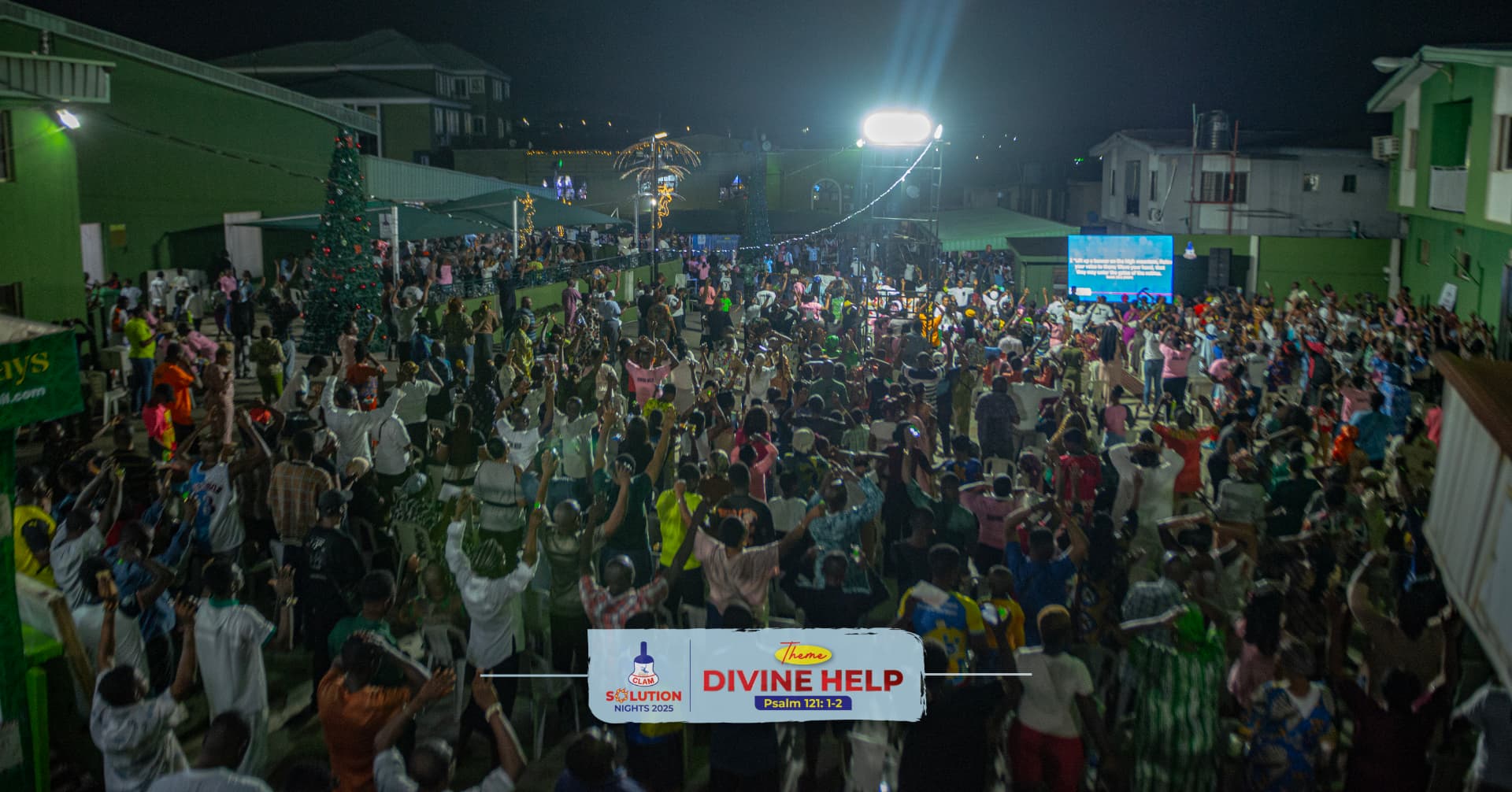 Crowd worshipping outdoors at CLAM Solution Nights